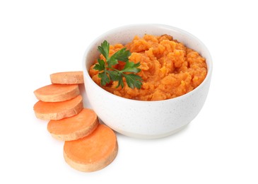 Photo of Tasty mashed sweet potato with parsley in bowl and cut vegetable isolated on white