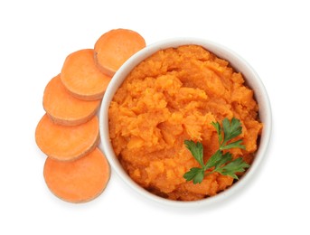 Photo of Tasty mashed sweet potato with parsley in bowl and cut vegetable isolated on white, top view