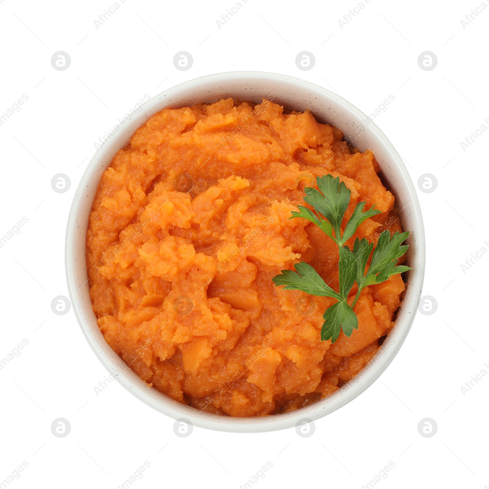 Photo of Tasty mashed sweet potato and parsley in bowl isolated on white, top view