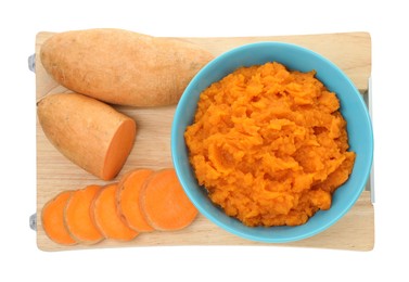 Photo of Tasty mashed sweet potato in bowl and fresh vegetables isolated on white, top view