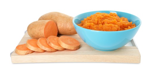 Photo of Tasty mashed sweet potato in bowl and fresh vegetables isolated on white