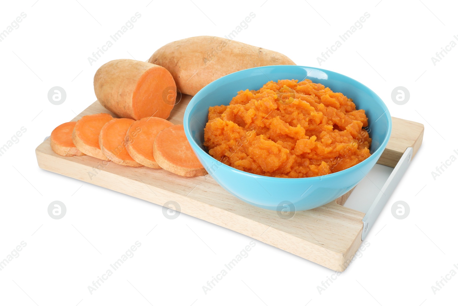 Photo of Tasty mashed sweet potato in bowl and fresh vegetables isolated on white