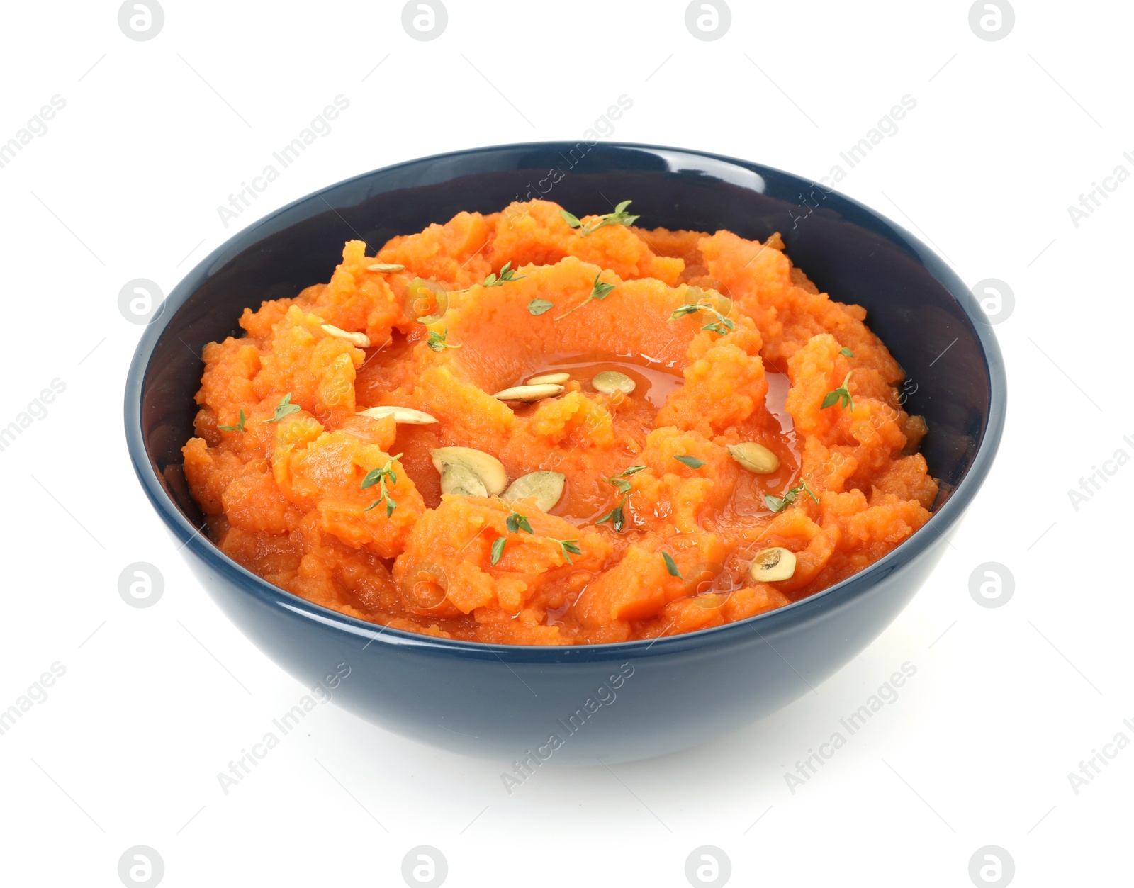 Photo of Tasty mashed sweet potato with pumpkin seeds and thyme in bowl isolated on white