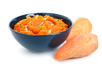 Photo of Tasty mashed sweet potato with pumpkin seeds in bowl and cut vegetables isolated on white