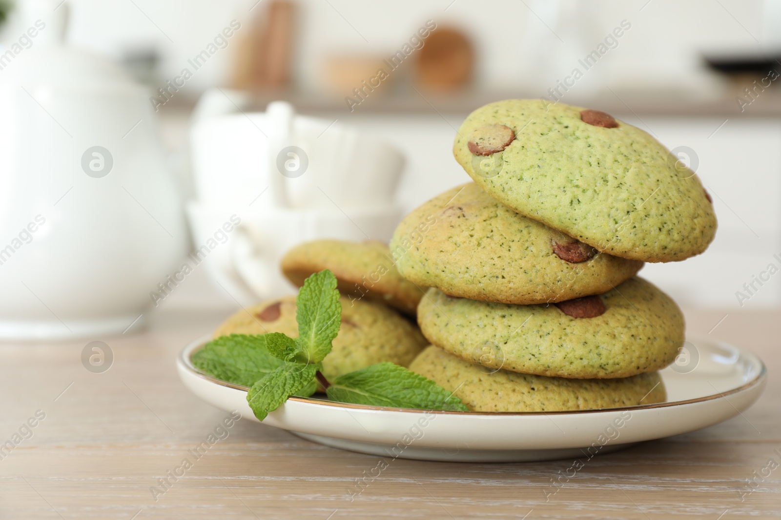 Photo of Delicious mint chocolate chip cookies on wooden table, closeup