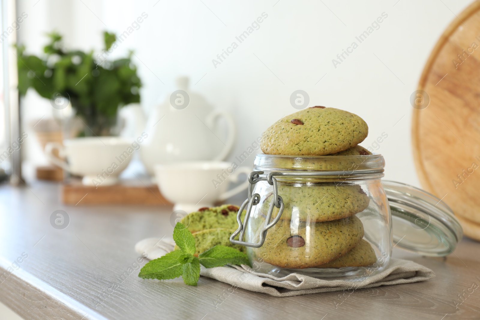 Photo of Delicious mint chocolate chip cookies on wooden table. Space for text