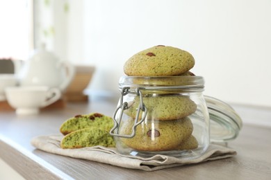 Photo of Delicious mint chocolate chip cookies on wooden table. Space for text