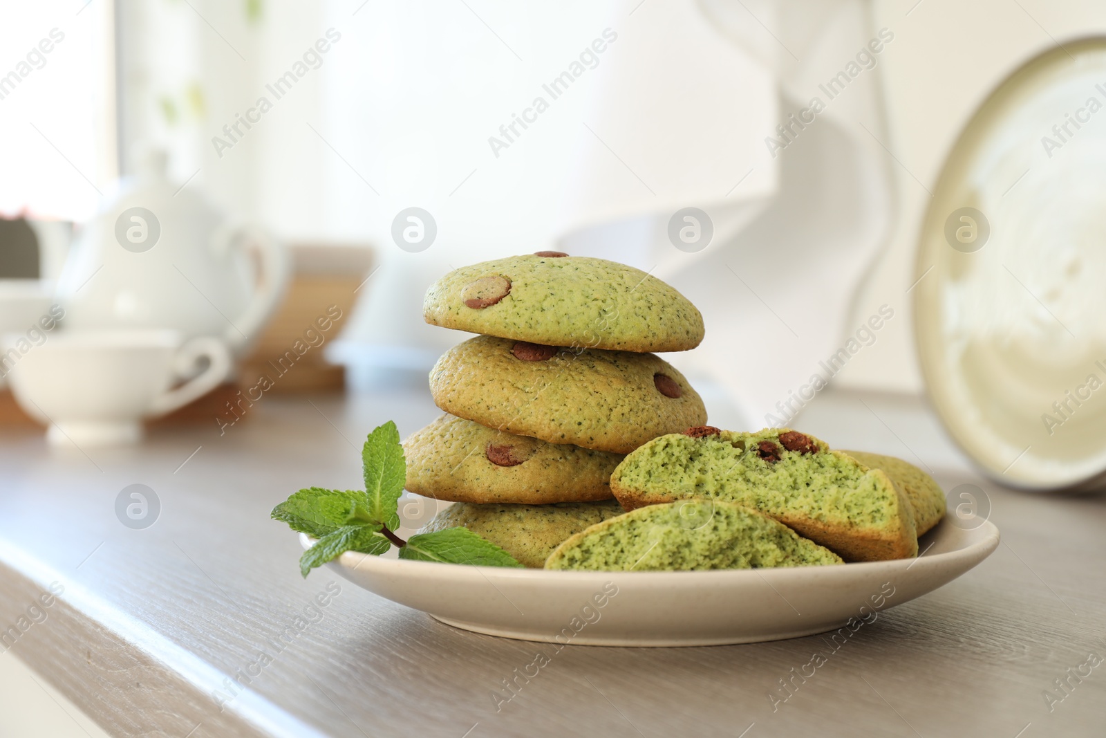 Photo of Delicious mint chocolate chip cookies on wooden table, closeup