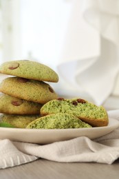 Photo of Delicious mint chocolate chip cookies on wooden table, closeup