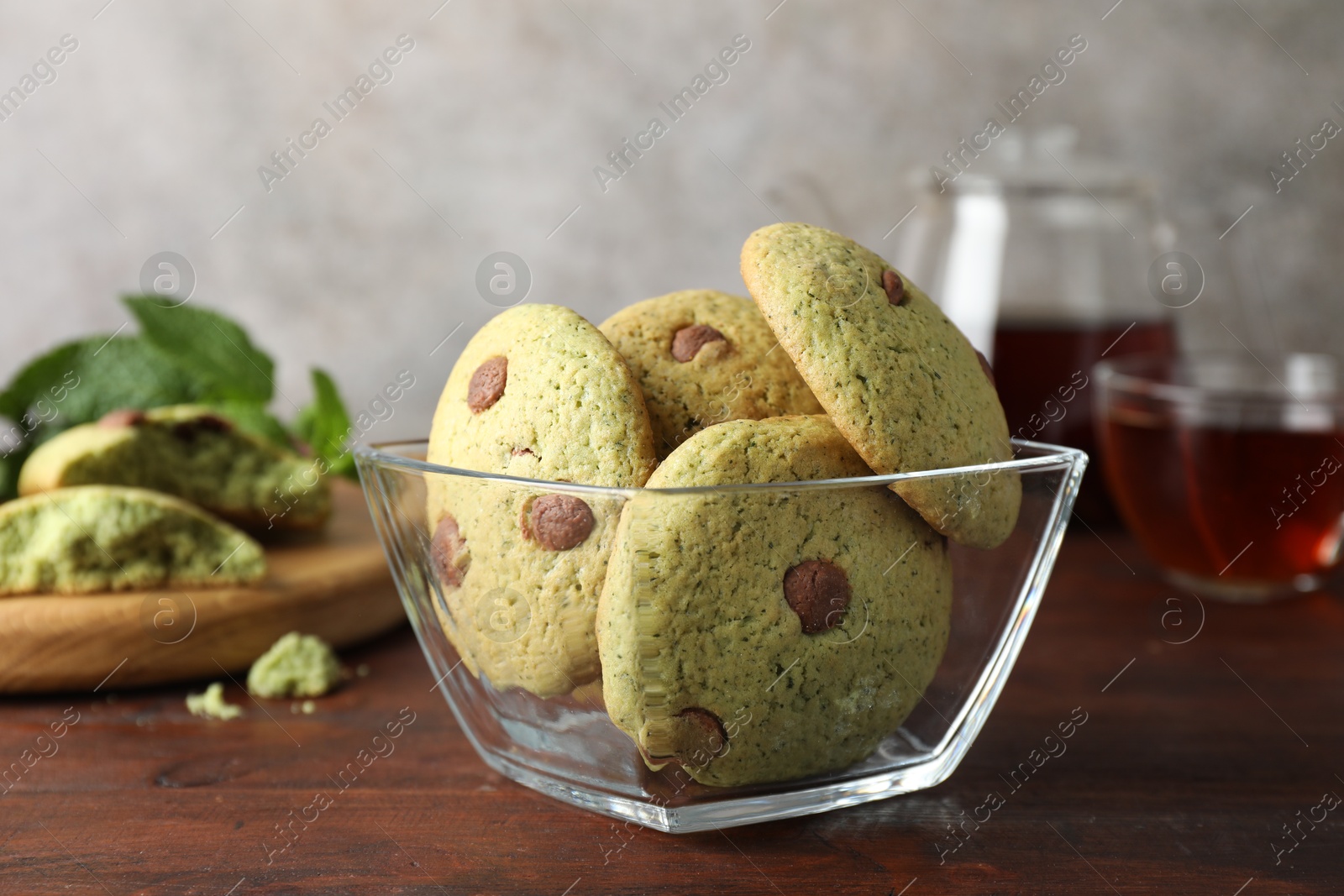 Photo of Delicious mint chocolate chip cookies on wooden table, closeup