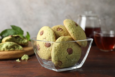 Photo of Delicious mint chocolate chip cookies on wooden table, closeup