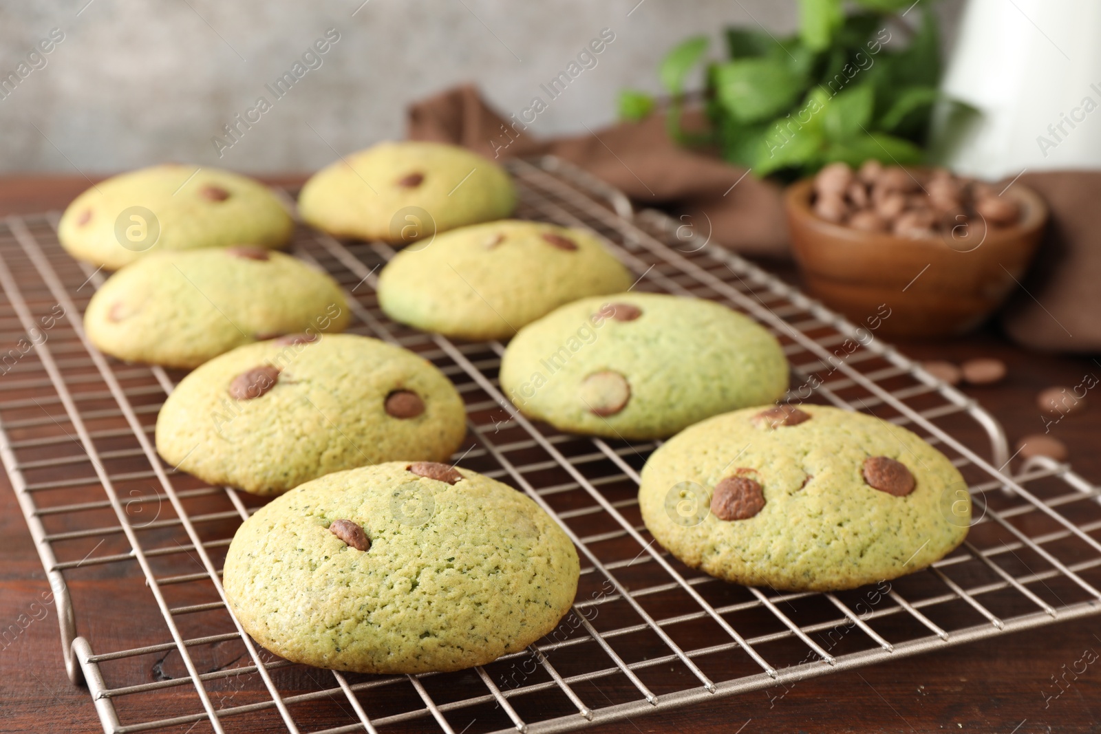 Photo of Delicious mint chocolate chip cookies on wooden table, closeup