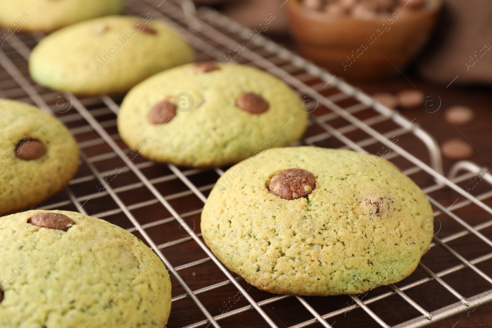 Photo of Delicious mint chocolate chip cookies on wooden table, closeup