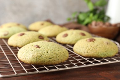 Photo of Delicious mint chocolate chip cookies on wooden table, closeup