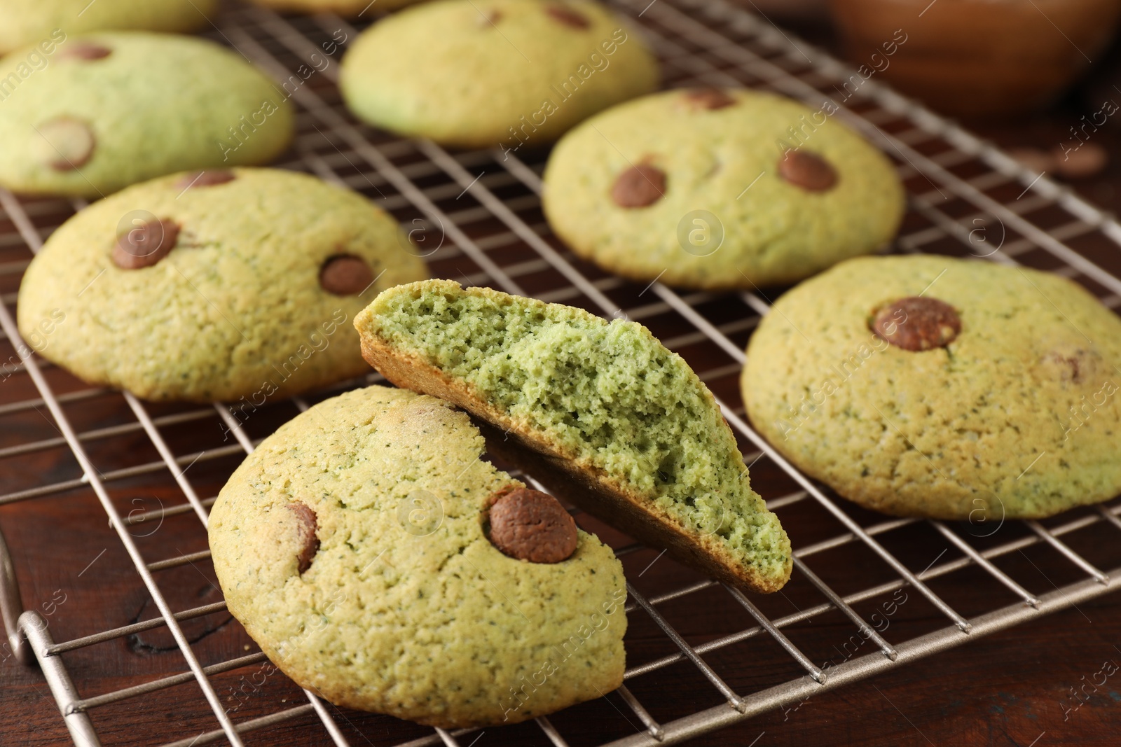 Photo of Delicious mint chocolate chip cookies on wooden table, closeup