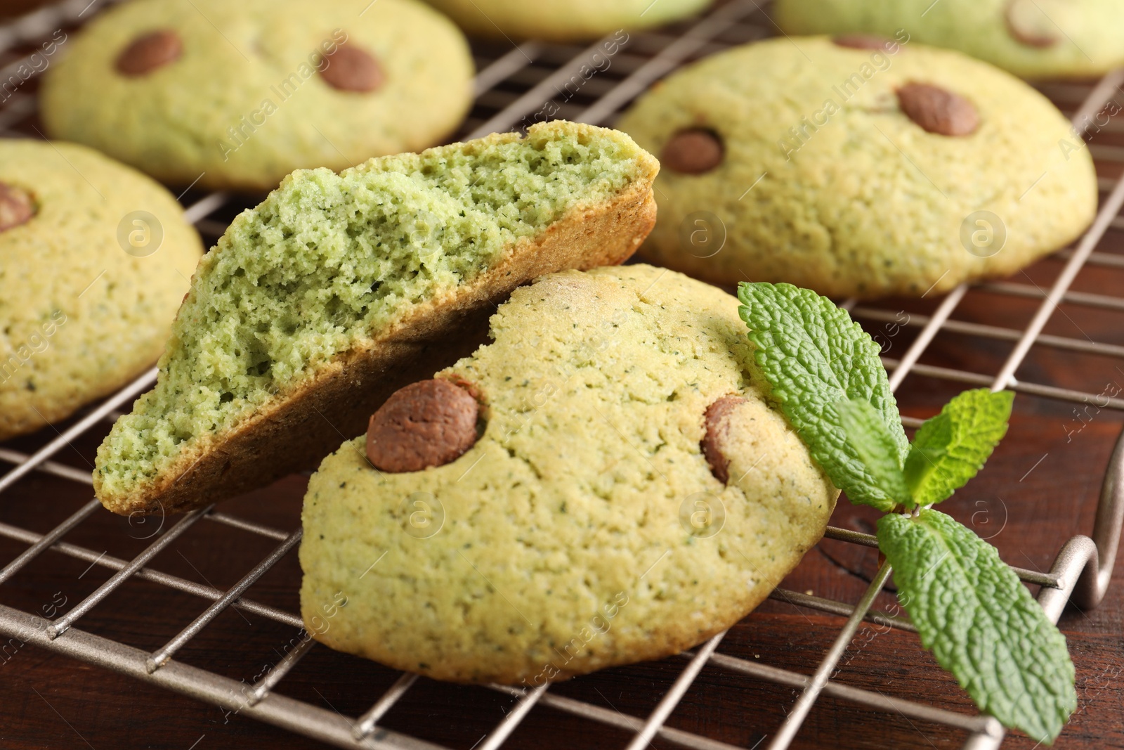 Photo of Delicious mint chocolate chip cookies on wooden table, closeup