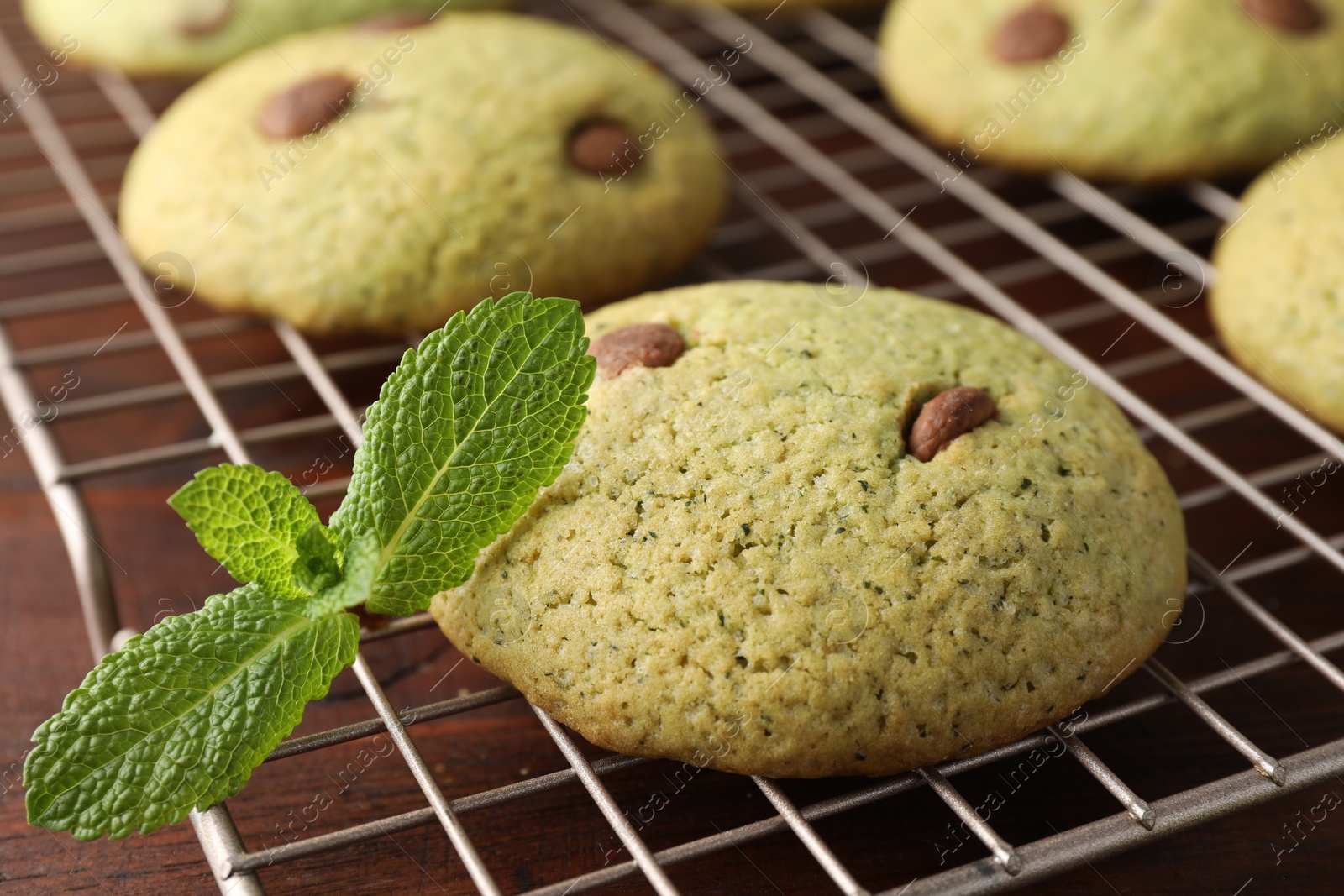 Photo of Delicious mint chocolate chip cookies on wooden table, closeup