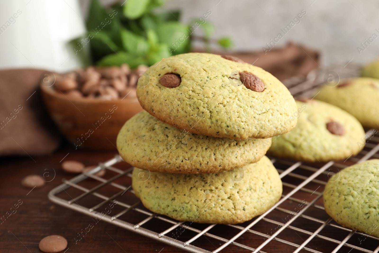 Photo of Delicious mint chocolate chip cookies on wooden table, closeup