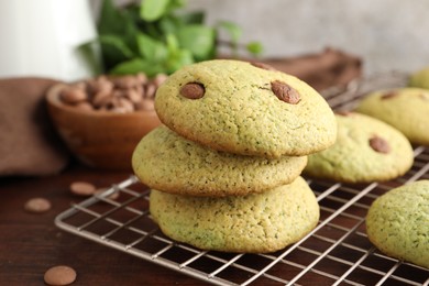 Photo of Delicious mint chocolate chip cookies on wooden table, closeup