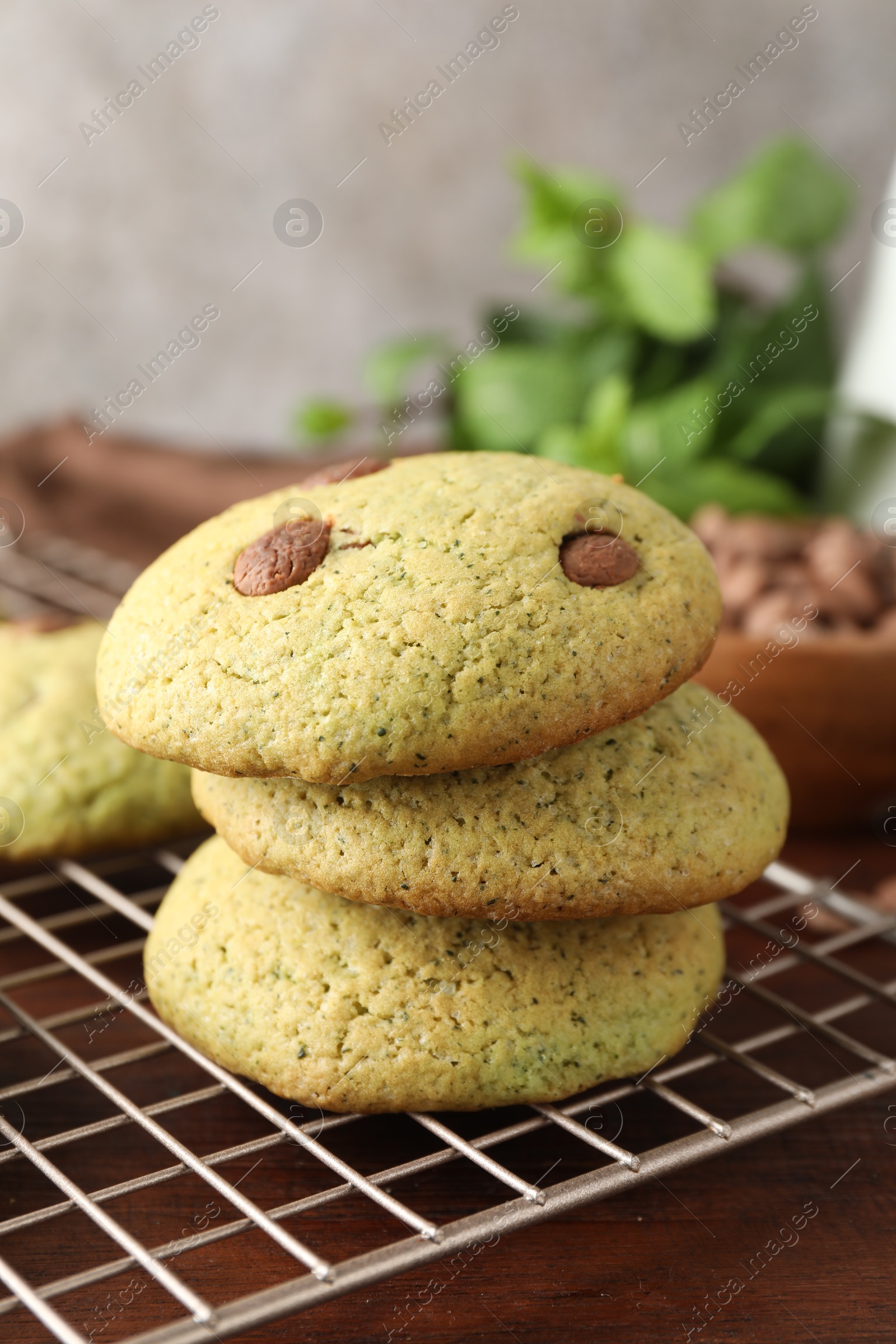 Photo of Delicious mint chocolate chip cookies on wooden table, closeup