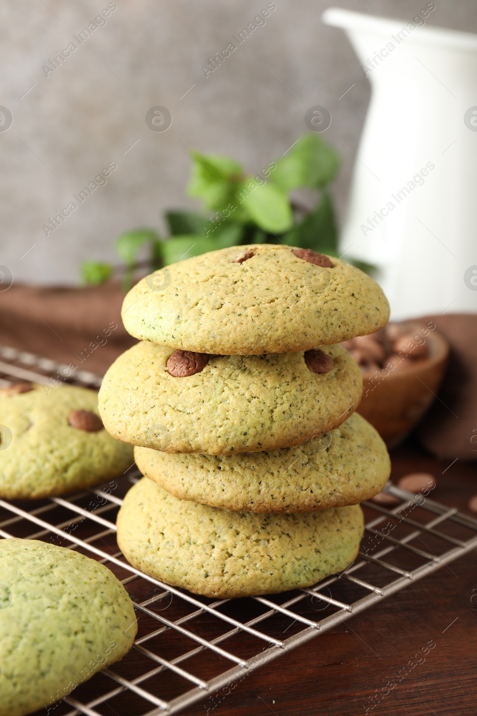 Photo of Delicious mint chocolate chip cookies on wooden table, closeup