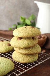 Photo of Delicious mint chocolate chip cookies on wooden table, closeup