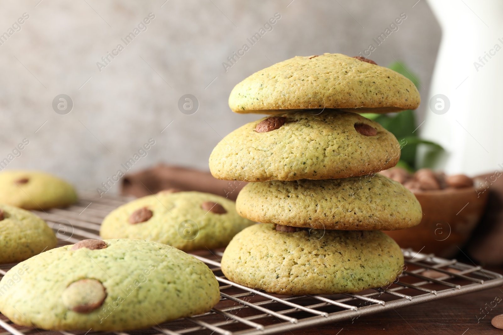 Photo of Delicious mint chocolate chip cookies on wooden table, closeup