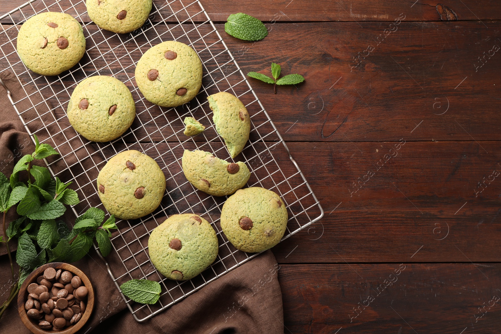 Photo of Delicious mint chocolate chip cookies on wooden table, flat lay. Space for text