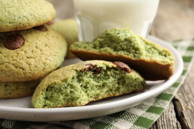 Photo of Delicious mint chocolate chip cookies on wooden table, closeup