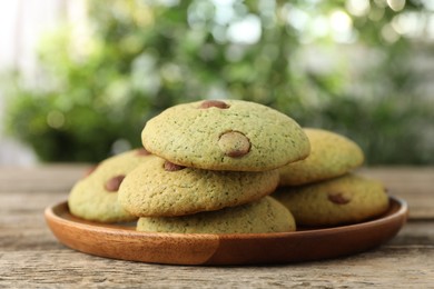 Photo of Delicious mint chocolate chip cookies on wooden table, closeup