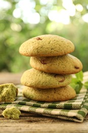 Photo of Delicious mint chocolate chip cookies on wooden table, closeup