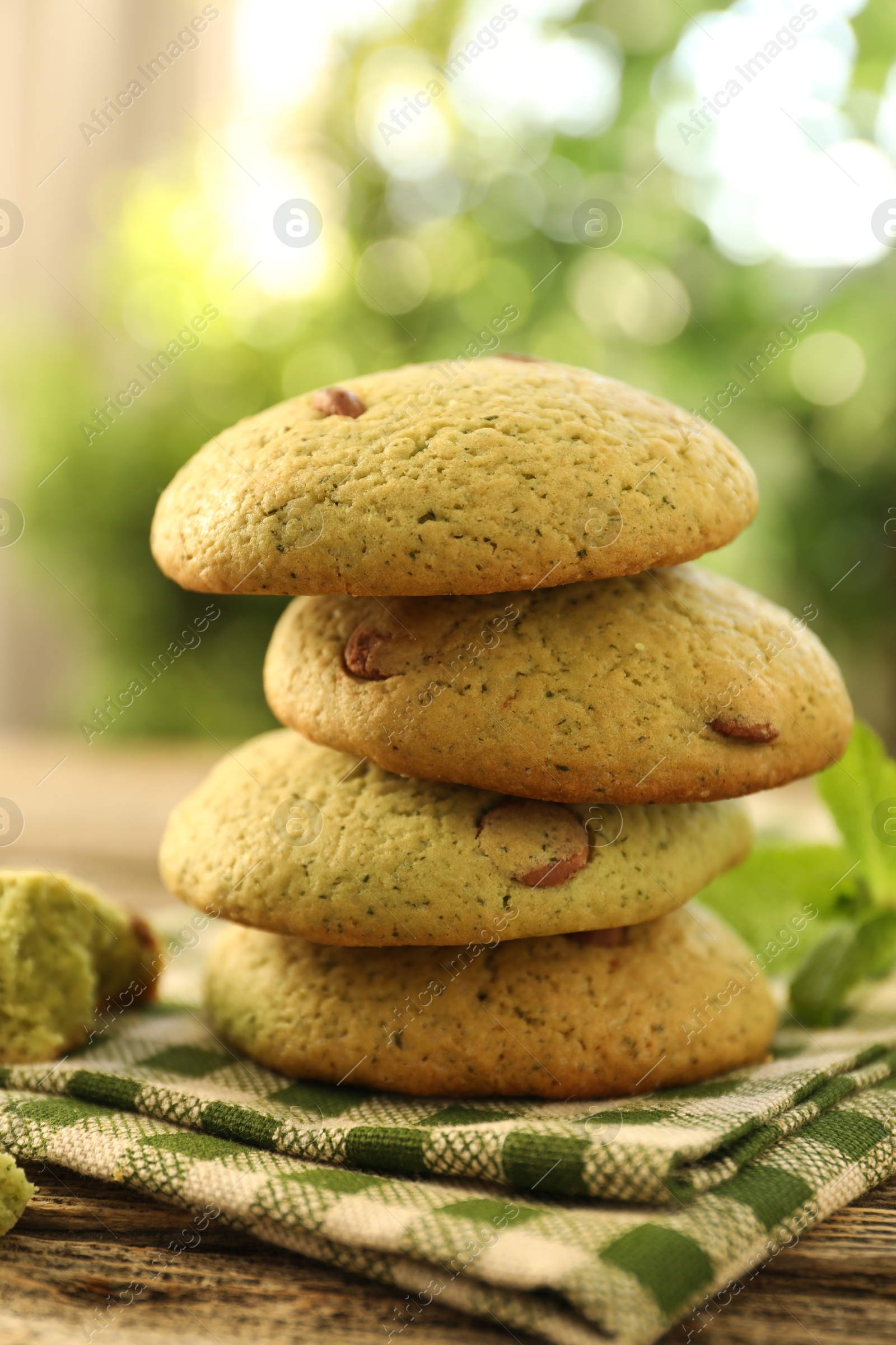 Photo of Delicious mint chocolate chip cookies on wooden table, closeup