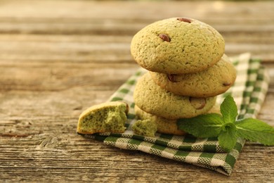 Photo of Delicious mint chocolate chip cookies on wooden table, closeup. Space for text