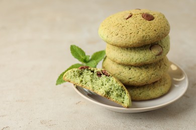 Photo of Delicious mint chocolate chip cookies on light table, closeup. Space for text