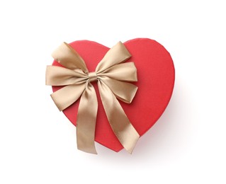 Photo of Heart shaped gift box with golden bow isolated on white, top view