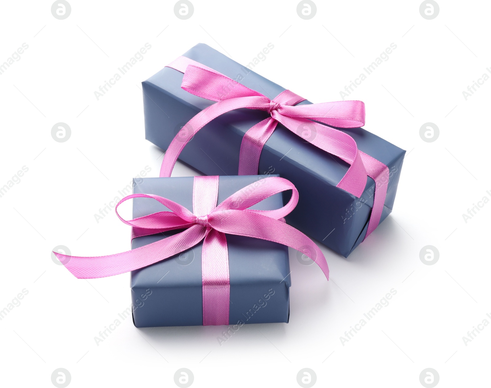 Photo of Beautiful gift boxes with pink bows isolated on white