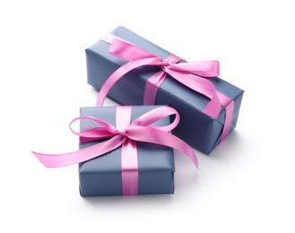 Photo of Beautiful gift boxes with pink bows isolated on white