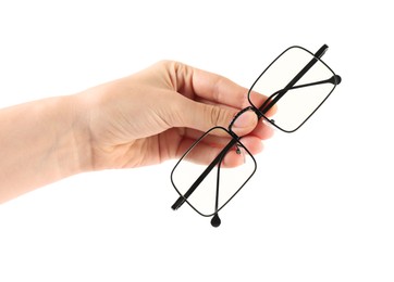 Photo of Woman holding glasses with black frame on white background, closeup