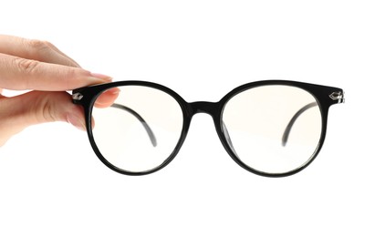 Photo of Woman holding glasses with black frame on white background, closeup