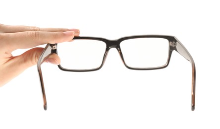 Photo of Woman holding glasses with black frame on white background, closeup