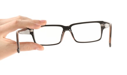 Photo of Woman holding glasses with black frame on white background, closeup