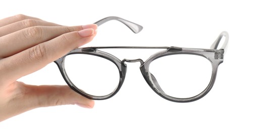 Photo of Woman holding glasses with grey frame on white background, closeup