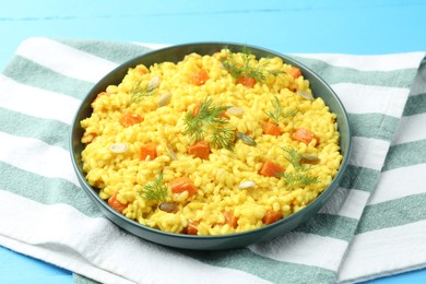 Photo of Delicious pumpkin risotto on light blue table