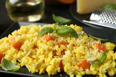 Photo of Delicious pumpkin risotto with parmesan and basil. closeup