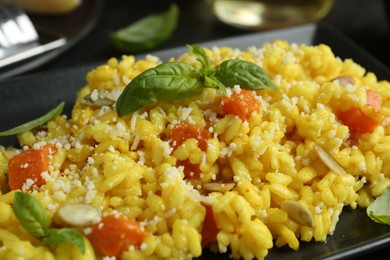 Photo of Delicious pumpkin risotto with parmesan and basil. closeup