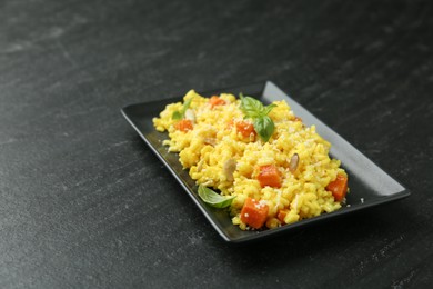 Photo of Delicious pumpkin risotto on black table, closeup