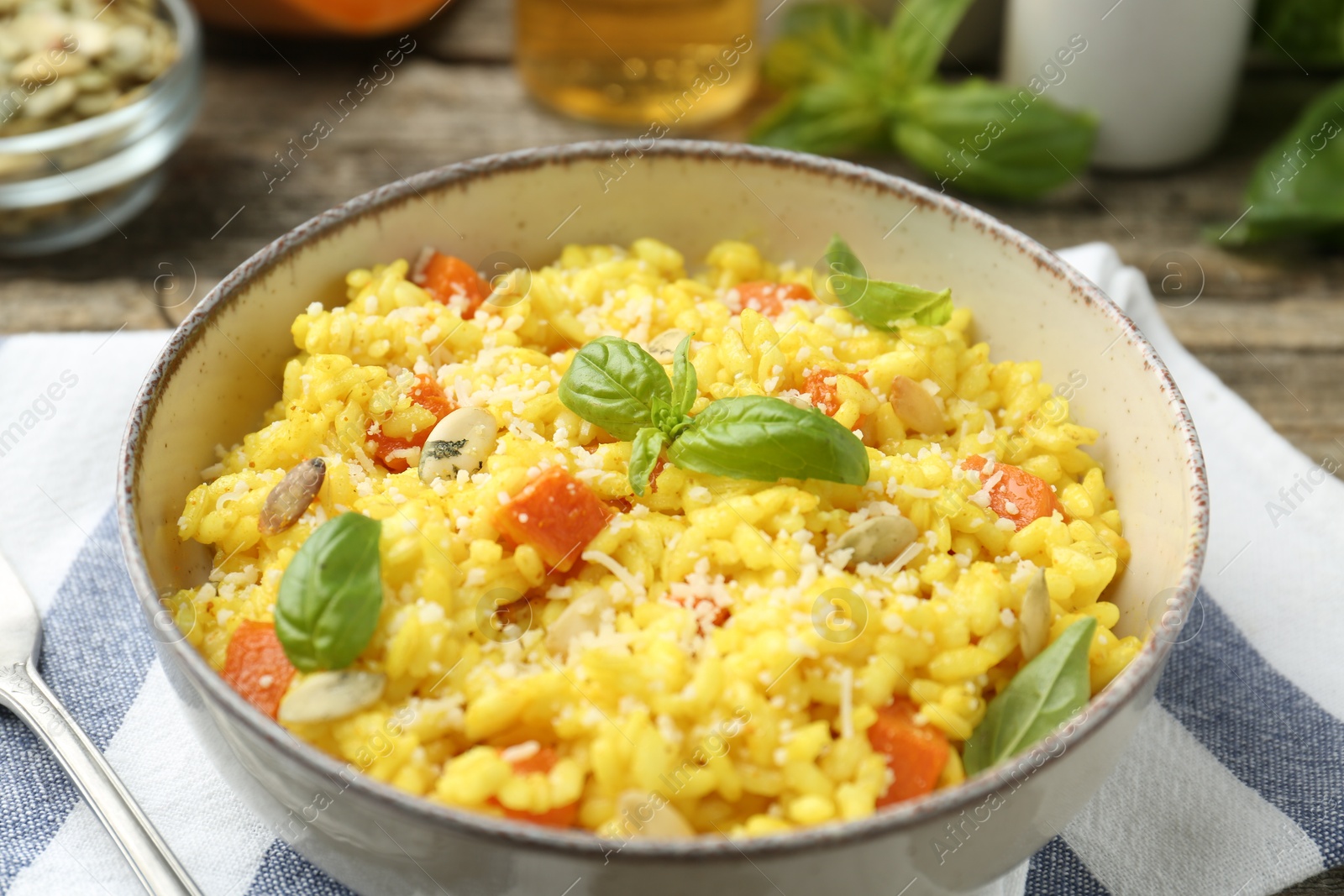 Photo of Delicious pumpkin risotto served on table, closeup