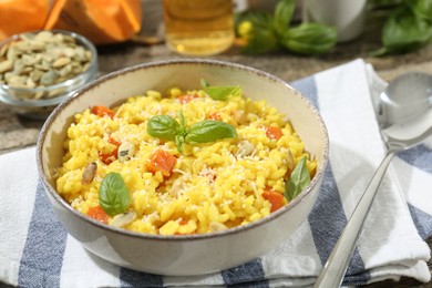 Photo of Delicious pumpkin risotto served on table, closeup