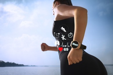 Image of Woman with smart watch running near river outdoors, closeup. Low angle view. Icons near device