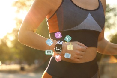 Image of Woman with smart watch running outdoors on sunny morning, closeup. Icons near device